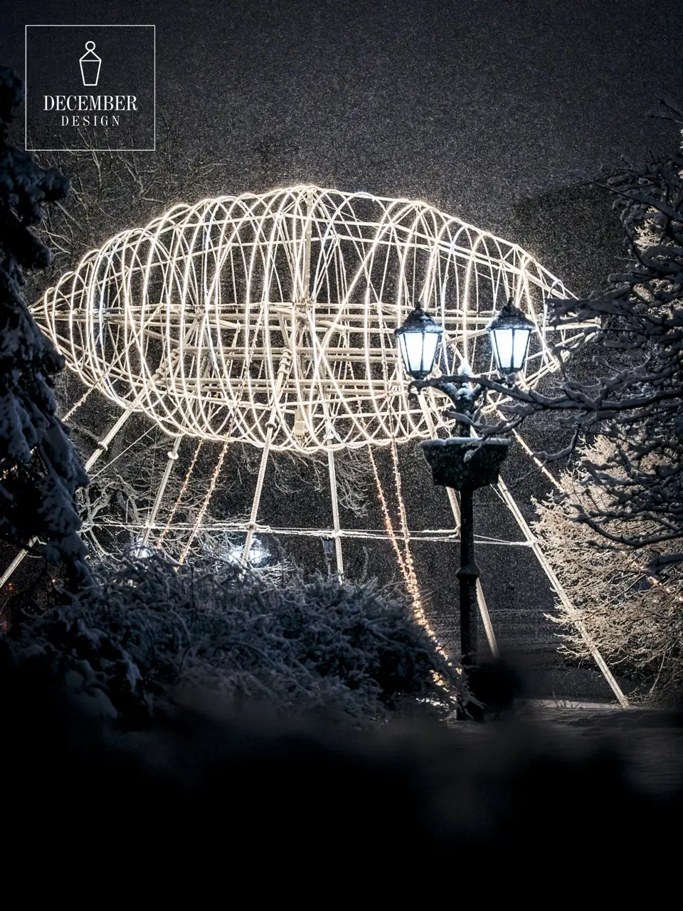 Airship of light through snowy trees with lantern in foreground