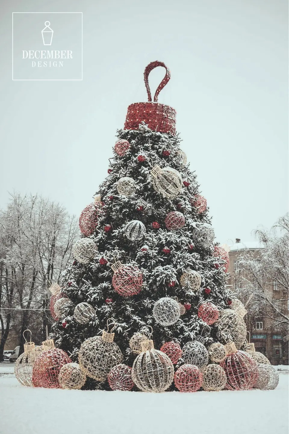 Frosted Christmas tree with red and silver balls in a snowy park on a winter day