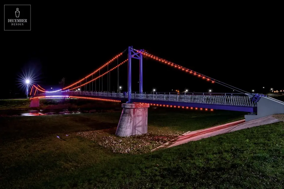 Ogre pedestrian bridge with a red light outline in a dark evening