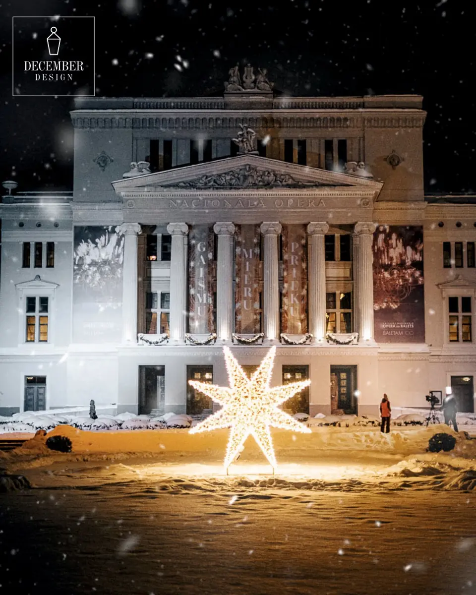The facade of the National Opera in the snowfall - a star of golden light shining in front