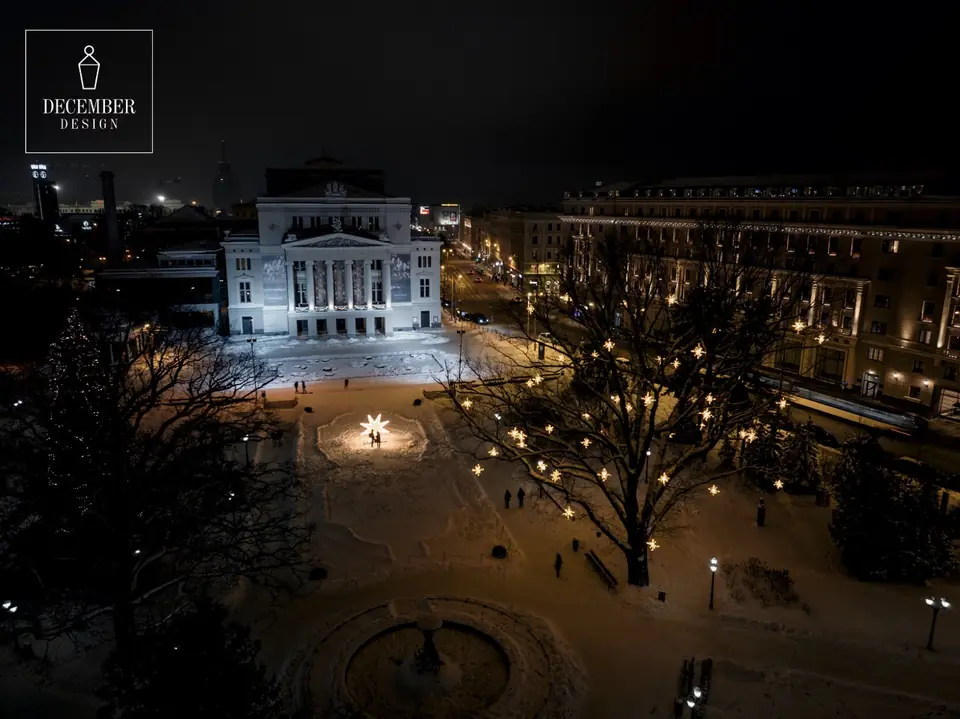 Bird's eye view of the National Opera building - a star of light shines in the square, the trees are illuminated