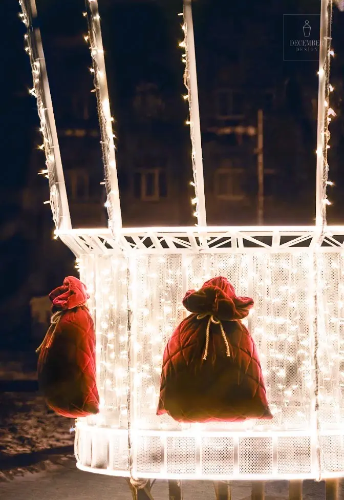 Close-up of a balloon basket with velvet gift bags illuminated by warm white LEDs