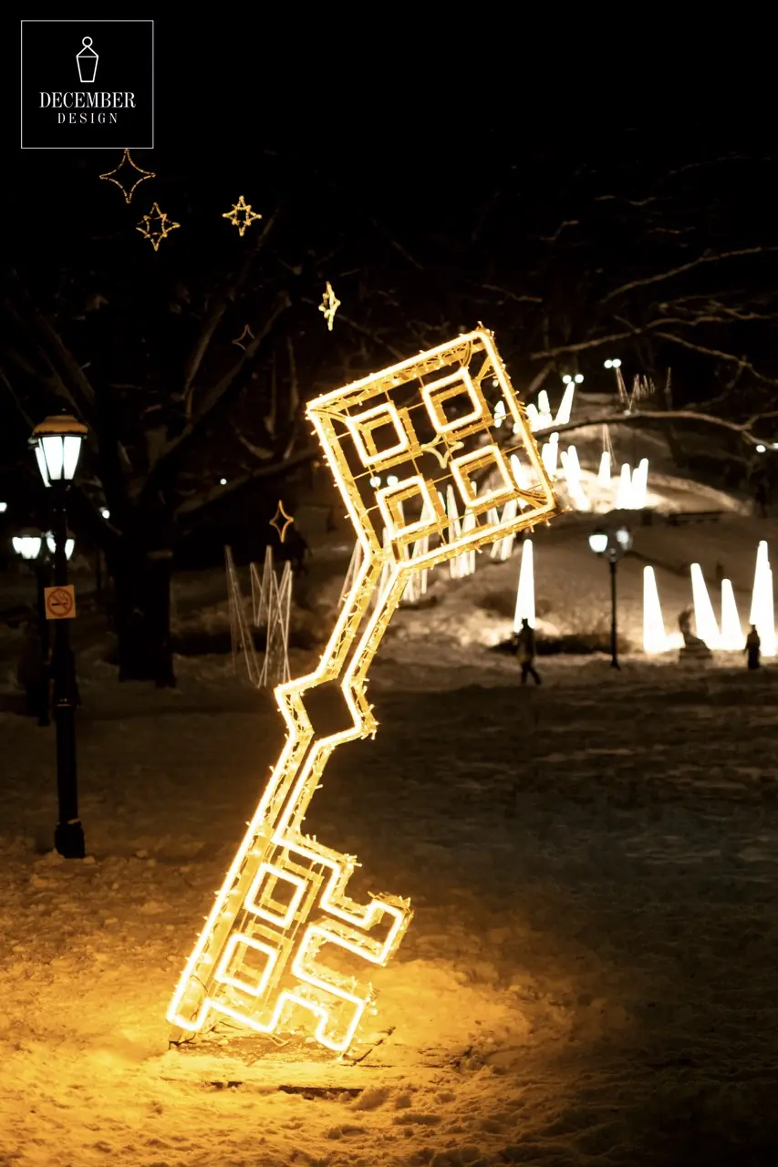 Illuminated key-shaped light sculpture in winter park at night
