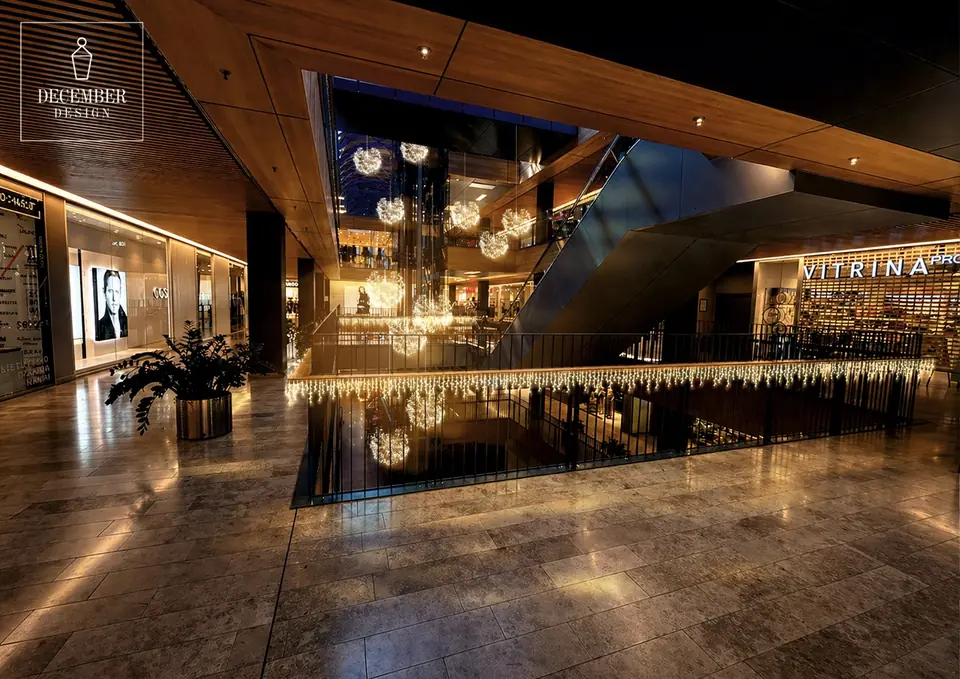 Mall interior with hanging light decorations and illuminated railings