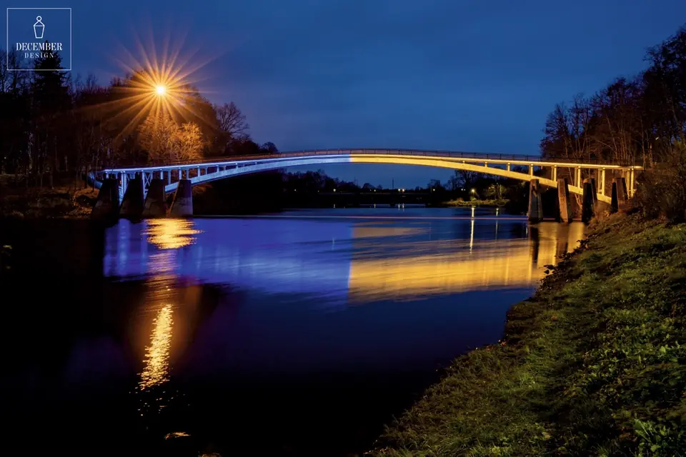 Ogre Arch Bridge in golden and blue light at night
