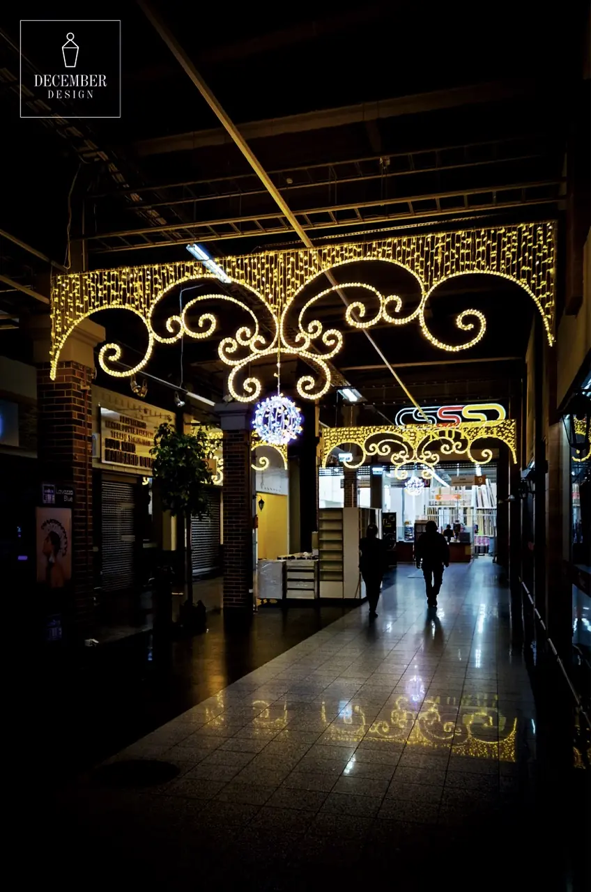 Interior arcade of Bruklinas shopping centre with illuminated ornaments above the hallway