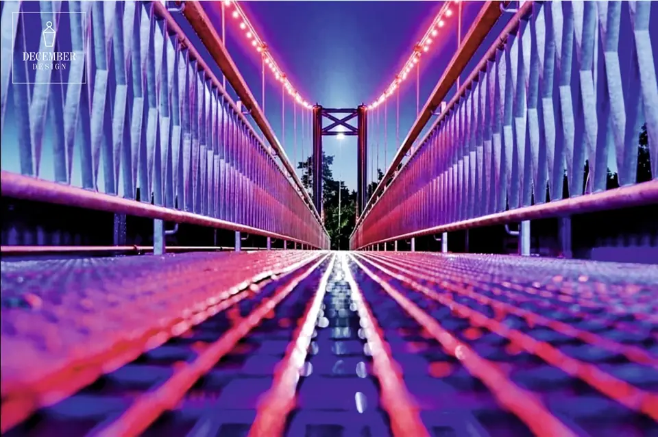 Ogre pedestrian bridge deck with red and purple light installation
