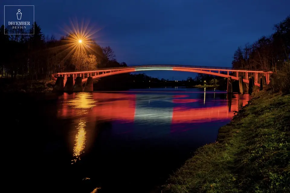 Ogre arched bridge in red light with bright reflection in the river