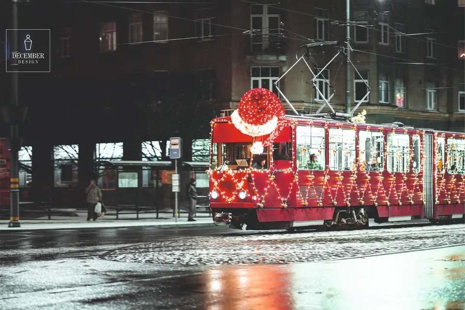 Illuminated Christmas tram in the night city at the stop