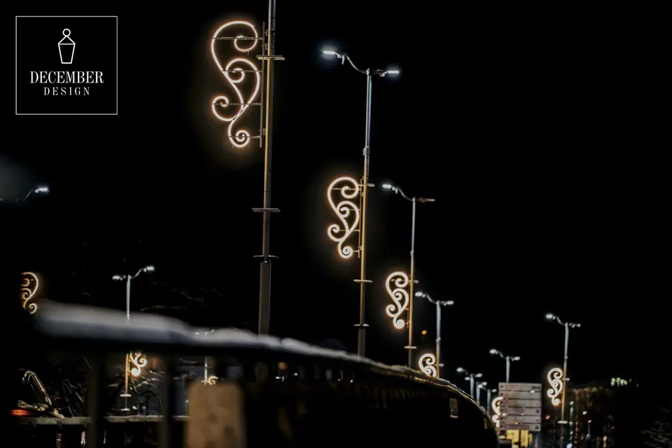 A row of street lamps with identical circular light decorations at night